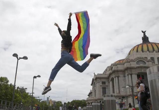 A member of the LGBT community celebrates sexual diversity in Mexico City, Saturday, June 26, 2021. Thousands of people marched through Paseo de la Reforma for one of the largest Gay pride events in Latin America. (Photo by Marco Ugarte/AP Photo)