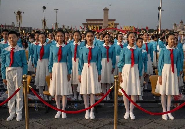 Chinese students from a choir stand together before a ceremony marking the 100th anniversary of the Communist Party on July 1, 2021 at Tiananmen Square in Beijing, China. (Photo by Kevin Frayer/Getty Images)