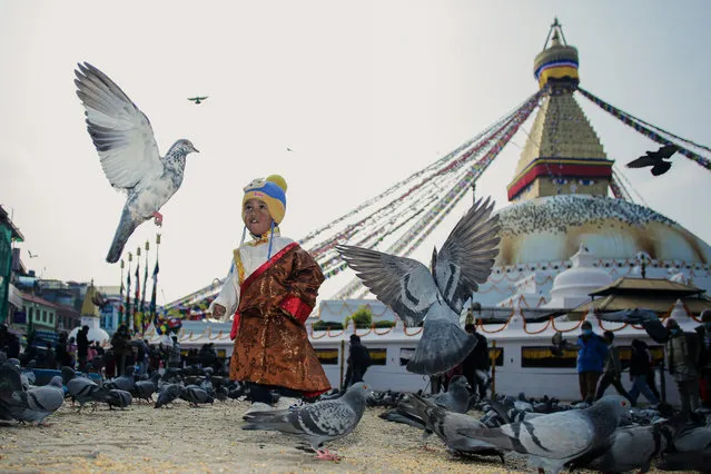 A young boy dressed in traditional Tamang dress plays with pigeons as Sonam Lhosar (the new year festival) is observed in Kathmandu, Nepal on February 2, 2022. (Photo by Amit Machamasi/ZUMA Press Wire/Rex Features/Shutterstock)