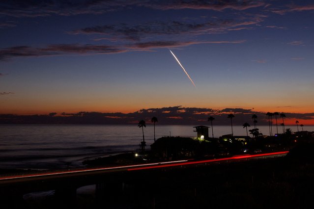 An evening launch of a SpaceX Falcon 9 rocket carrying 20 Starlink V2 Mini satellites, from Space Launch Complex at Vandenberg Space Force Base is seen over the Pacific Ocean from Encinitas, California, U.S., June 23, 2024. (Photo by Mike Blake/Reuters)