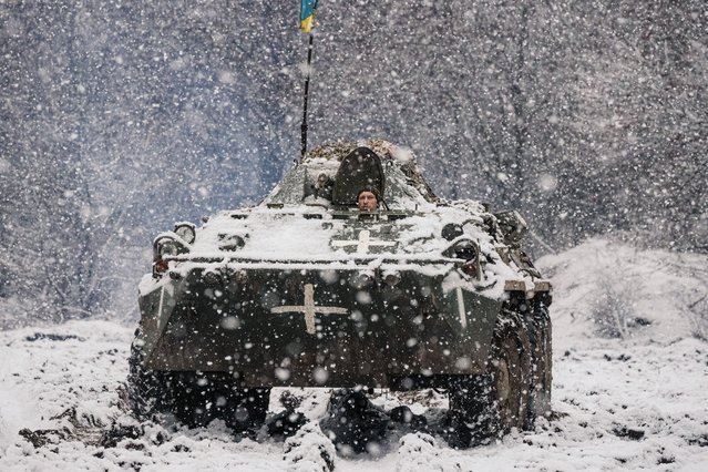 Members of a Ukrainian tank unit drive an armored personnel carrier toward the front line near Bakhmut, Ukraine on Tuesday, March 7, 2023. Ukrainian officials said on Tuesday that the Wagner group had shifted to using more professional soldiers in the battle for Bakhmut as its supply of prisoner recruits dwindled, suggesting that Ukraine may be hoping its battle in the city can severely damage a highly effective fighting force for Russia. (Photo by Daniel Berehulak/The New York Times)