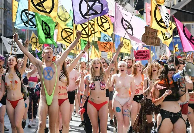 Protestors from the Extinction Rebellion march on day six of protests stopping traffic in the city district of Melbourne, Australia on October 12, 2019. (Photo by ydney Low/ZUMA Wire/Rex Features/Shutterstock)