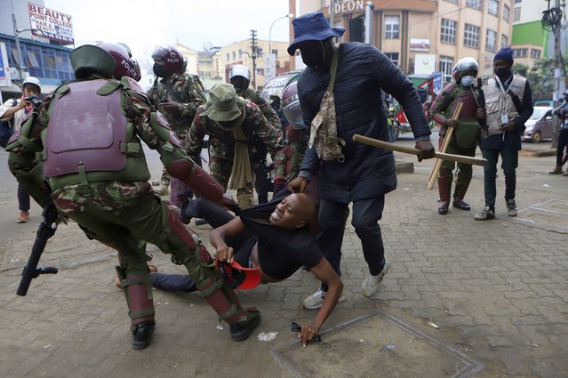 A protester is arrested in Nairobi, Kenya, Thursday August 8, 2024, during a demonstration against hunger. (Photo by Andrew Kasuku/AP Photo)