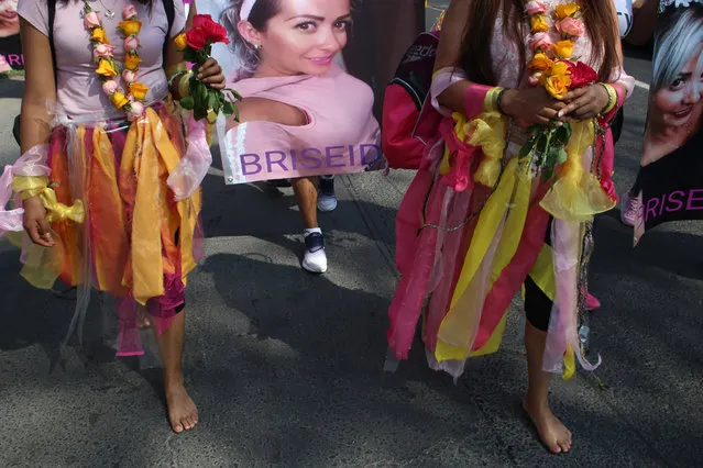 Women walk barefoot on asphalt, clothed in shreds of organza in pastel shades of pink and yellow, the favorite colors of murder victim Briseida Carreno, during a ceremony in her honor, in Ecatepec, a suburb of Mexico City, Saturday, November 23, 2019. Mexico City’s mayor issued a gender alert this week for the capital, meaning that 20 of Mexico’s 31 federal entities have declared emergencies over the issue. Activists want more action, and are planning demonstrations to mark Monday’s International Day for the Elimination of Violence Women. (Photo by Alicia Fernandez/AP Photo)