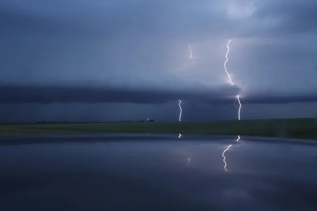 Cloud to ground lightning strikes during a supercell thunderstorm, May 9, 2017 in Lamb County, Texas. Tuesday was the group's second day in the field for the 2017 tornado season for their research project titled “TWIRL”. With funding from the National Science Foundation and other government grants, scientists and meteorologists from the Center for Severe Weather Research try to get close to supercell storms and tornadoes trying to better understand tornado structure and strength, how low-level winds affect and damage buildings, and to learn more about tornado formation and prediction. (Photo by Drew Angerer/Getty Images)