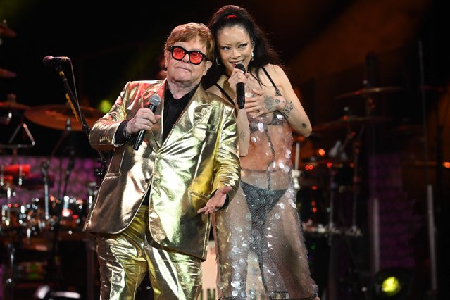 British legendary singer Elton John (L) performs with Rina Sawayama (R) on the Pyramid Stage on day 5 of the Glastonbury festival in the village of Pilton in Somerset, southwest England, on June 25, 2023. Elton John closes out Britain's legendary Glastonbury Festival on Sunday in what has been billed as his final UK performance. The 76-year-old pop superstar is winding down a glittering live career with a global farewell tour, having played his last concerts in the United States in May ahead of a final gig in Stockholm on July 8. (Photo by Oli Scarff/AFP Photo)