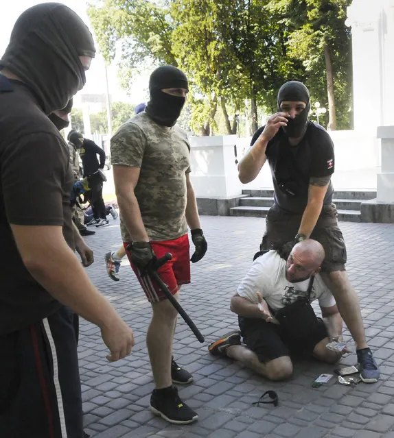 Ukrainian plain clothed policemen arrest a pro-Russian activist after mass violence in Ukraine's border city of Kharkiv Monday, August 3, 2015. The police have opened a criminal investigation after violence occurred near the office of the Opposition Bloc. (Photo by AP Photo/Stringer)