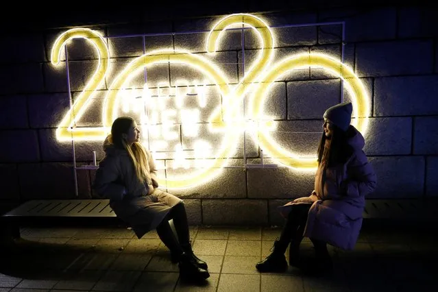 Women pose for a picture in front of a 2020 luminous sign during New Year’s Eve in Seoul, South Korea on December 31, 2019. (Photo by Kim Hong-Ji/Reuters)