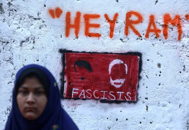 A woman walks past a graffiti on a wall during a protest against a new citizenship law in Mumbai, India, January 31, 2020. (Photo by Francis Mascarenhas/Reuters)