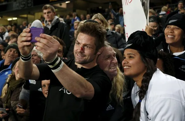 New Zealand's All Black's captain Richie McCaw takes a selfie with fans after winning the Bledisloe Cup rugby match against Australia at Eden Park in Auckland, August 15, 2015. (Photo by Nigel Marple/Reuters)