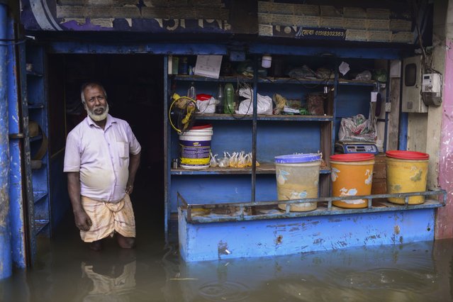 A man stands at the doorway of his flooded shop in Sylhet, Bangladesh, Monday, June 20, 2022. (Photo by Mahmud Hossain Opu/AP Photo)