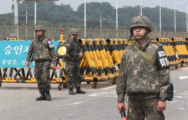 South Korean army soldiers stand guard at Unification Bridge near the border village of Panmunom in Paju, South Korea, Friday, August 21, 2015. South Korea fired dozens of shells Thursday at rival North Korea after the North lobbed several rounds across the world's most heavily armed border and threatened to take further action unless Seoul ends its loudspeaker broadcasts. The North denied it fired any shots and warned of retaliation for what it called a serious provocation. (Photo by Ahn Young-joon/AP Photo)