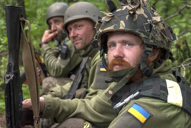 Ukrainian servicemen take rest in a recently retaken village north of Kharkiv, east Ukraine, Sunday, May 15, 2022. (Photo by Mstyslav Chernov/AP Photo)