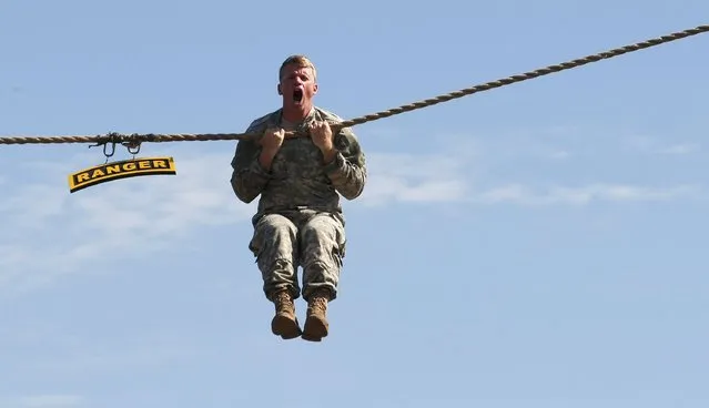 A U.S. Army Ranger shows skills during a demonstration at Ranger school graduation at Fort Benning in Columbus, Georgia August 21, 2015. (Photo by Tami Chappell/Reuters)