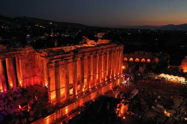 The Temple of Bacchus is illuminated during the opening of Baalbeck International Festival, in Baalbeck, Lebanon on July 8, 2022. (Photo by Issam Abdallah/Reuters)