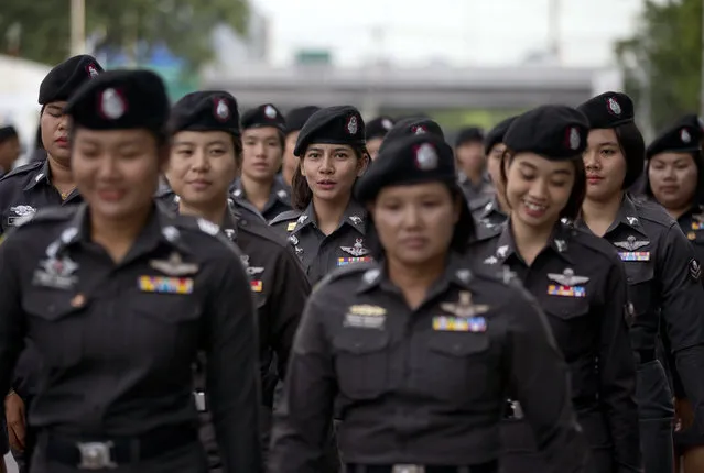 Police officers deploy to positions outside Supreme Court ahead the delivery of a verdict on charges accusing Thailand's former Prime Minister Yingluck Shinawatra of negligence in implementing a rice subsidy in Bangkok Thailand, Friday, August 25, 2017. Police stood guard Friday morning as Thailand's Supreme Court prepared to rule on whether Yingluck was guilty of criminal negligence for implementing a rice subsidy program that cost the government as much as $17 billion. (Photo by Gemunu Amarasinghe/AP Photo)