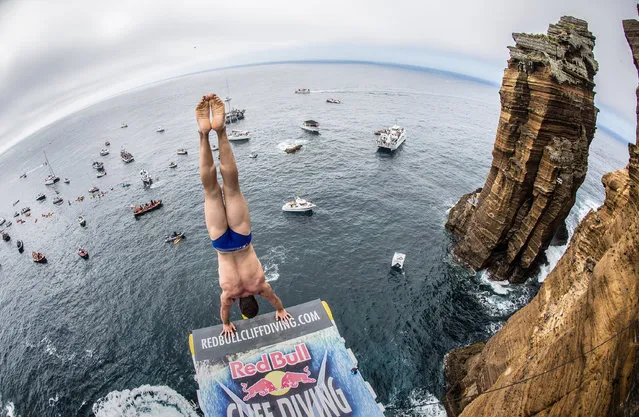 In this handout image provided by Red Bull, Michal Navratil of the Czech Republic prepares to launch an armstand dive from the 27 metre platform at Islet Franca do Campo during the third stop of the Red Bull Cliff Diving World Series, Sao Miguel, Azores, Portugal on July 9th 2016. (Photo by Romina Amato/Red Bull via Getty Images)