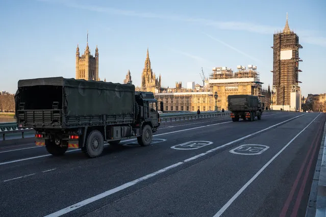 Military vehicles cross Westminster Bridge after members of the 101 Logistic Brigade of the British Army delivered a consignment of medical masks to St Thomas' hospital on March 24, 2020 in London, England. British Prime Minister, Boris Johnson, announced strict lockdown measures urging people to stay at home and only leave the house for basic food shopping, exercise once a day and essential travel to and from work. The Coronavirus (COVID-19) pandemic has spread to at least 182 countries, claiming over 10,000 lives and infecting hundreds of thousands more. (Photo by Leon Neal/Getty Images)