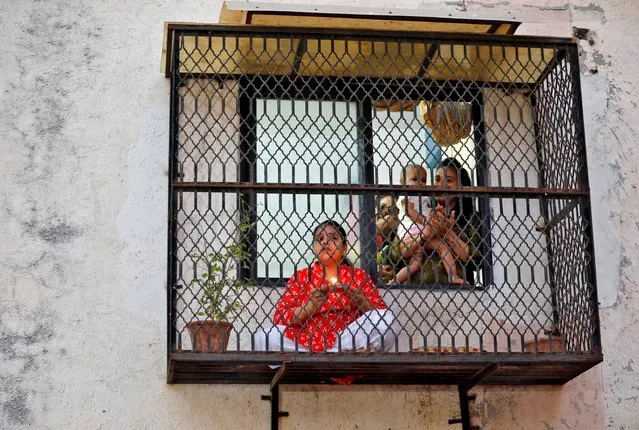 Hindu devotees pray for the eradication of coronavirus during Chaitra Navratri amid a nationwide lockdown to limit the spreading of the virus, in Ahmedabad, India, March 27, 2020. (Photo by Amit Dave/Reuters)