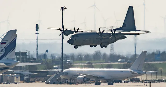 In this March 25, 2020, file photo, an Italian Air Force plane carrying two patients from Italy believed to have COVID-19, lands at Leipzig Airport, Germany. In the rare position of having beds to spare, German hospitals have taken in dozens of patients from Italy and France. (Photo by Hendrik Schmidt/dpa via AP Photo/File)