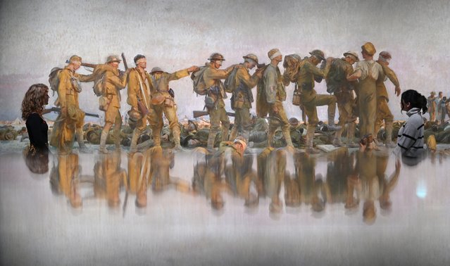 Gallery assistants study a detail of “Gassed”, a 1919 oil painting by US artist John Singer Sargent inside the new Blavatnik Art, Film and Photography Galleries at The Imperial War Museum in London on November 9, 2023, at a press preview ahead of the Galleries' opening. The Galleries will include around 500 works from IWM's collection, showcasing some of the vast and era-defining film and photography collections, which include over 23,000 hours of footage and over 12 million photographs. (Photo by Justin Tallis/AFP Photo)