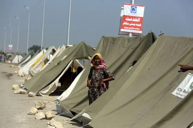 An affected woman takes refuge in a tent area after her home was hit by floods in Sukkur, Pakistan, Sunday, September 4, 2022. (Photo by Fareed Khan/AP Photo)