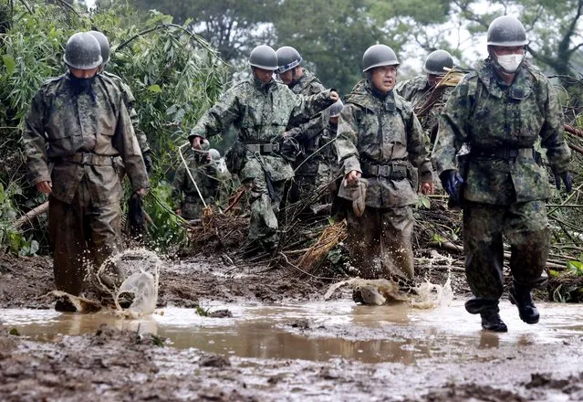 Japanese Self-Defence Force soldiers conduct search and rescue operation at a landslide site caused by Typhoon Nanmadol in Mimata Town, Miyazaki Prefecture on Japan's southernmost main island of Kyushu on September 19, 2022, in this photo taken by Kyodo. (Photo by Kyodo News via Reuters)