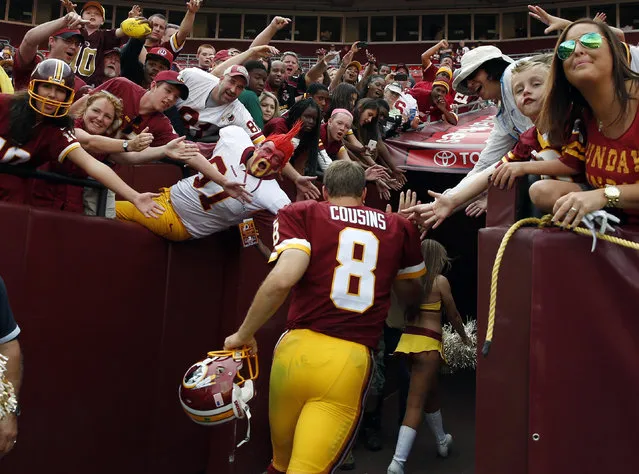 Washington Redskins quarterback Kirk Cousins (8) runs off the field after an NFL football game against the Jacksonville Jaguars on Sunday, September 14, 2014, in Landover, Md. The Redskins won 41-10. (Photo by Evan Vucci/AP Photo)