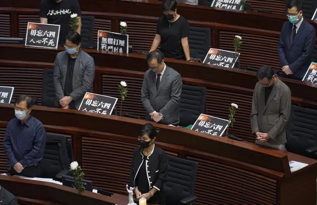 Pan-democratic legislators observe one minute of silence for the 31st anniversary of Tiananmen crackdown before a Legislative Council meeting to debate national anthem bill in Hong Kong, Thursday, June 4, 2020. On the anniversary of Tiananmen crackdown, Hong Kong continued debating a contentious law that makes it illegal to insult or abuse the Chinese national anthem. (Photo by Vincent Yu/AP Photo)