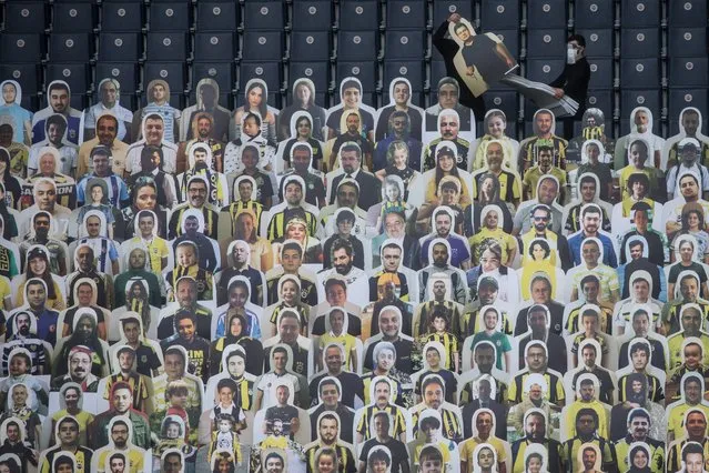 Workers install cut-out portraits of Fenerbahce SK fans at Fenerbahce Sukru Saracoglu Stadium on June 10, 2020 in Istanbul, Turkey. Fenerbahce SK will play Kayserispor in an empty stadium on Friday June 12, in the first Turkish Super League match since the Turkish Football League was cancelled on March 20th due to the coronavirus outbreak. As infection rates of the coronavirus continue to drop and after more than a month of weekend lockdowns, Turkey has begun reopening procedures, allowing bars, restaurants, cafes and some sporting events to begin operations under new restrictions. Limited domestic flights have restarted and the stay-at-home curfew for citizens under 20 and over 65 has been lifted. (Photo by Chris McGrath/Getty Images)