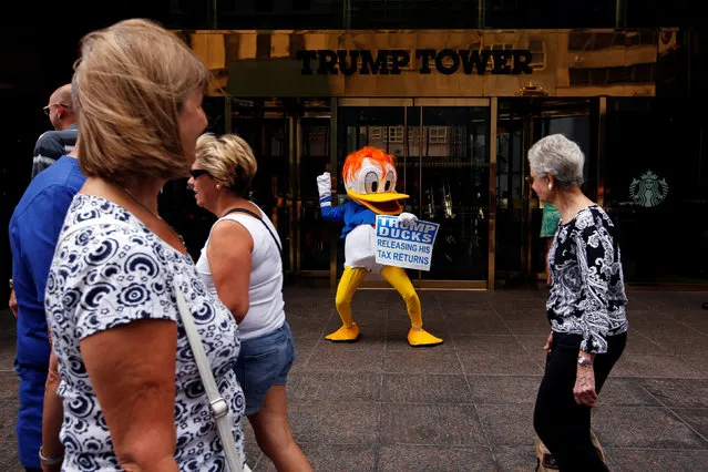 An activist by the name of DJ Quacker holds a sign asking Republican presidential nominee Donald Trump to release his tax forms, outside of Trump Tower in New York City, New York, U.S., September 6, 2016. (Photo by Lucas Jackson/Reuters)