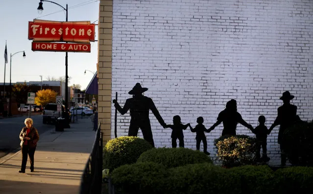 A mural decorates a downtown building in Lumberton, N.C., Monday, October 30, 2017. In Robeson County, whites, blacks and Native Americans split the population – and many often remark at how well they've overcome the scars of segregation to struggle together, side by side. (Photo by David Goldman/AP Photo)
