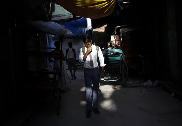 A schoolboy walks through an alley during the early morning in the old quarters of Delhi, September 3, 2013. (Photo by Anindito Mukherjee/Reuters)