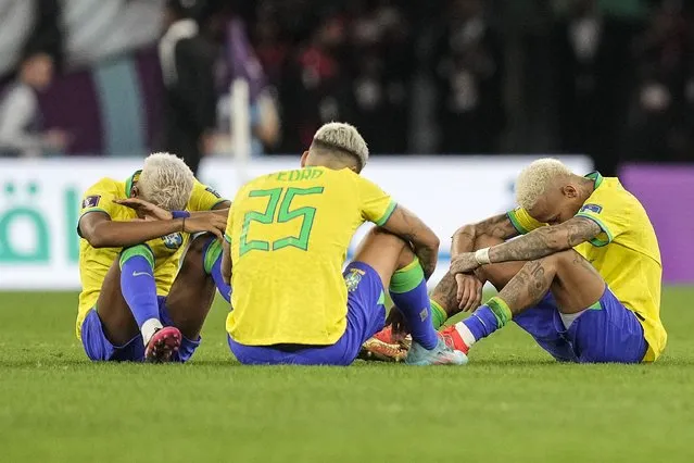 Brazil's Rodrygo, Brazil's Pedro and Brazil's Neymar, from right, sit on the pitch after losing the World Cup quarterfinal soccer match between Croatia and Brazil, at the Education City Stadium in Al Rayyan, Qatar, Friday, December 9, 2022. (Photo by Martin Meissner/AP Photo)