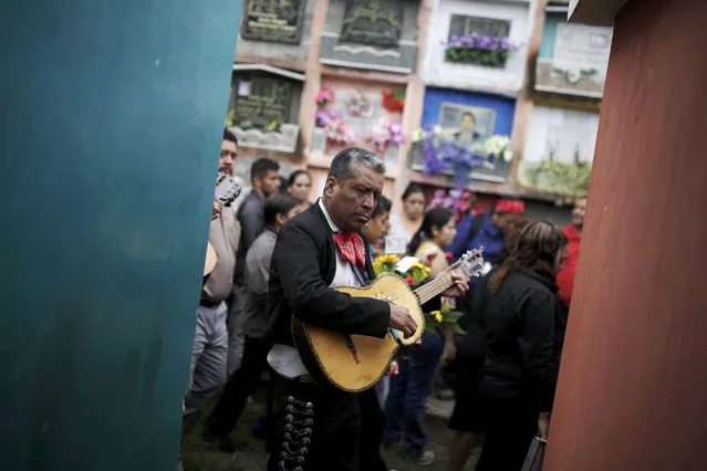 A man plays a mariachi during the funeral of members of the Sandoval family, mudslide victims in Santa Catarina Pinula, on the outskirts of Guatemala City, October 4, 2015. (Photo by Josue Decavele/Reuters)