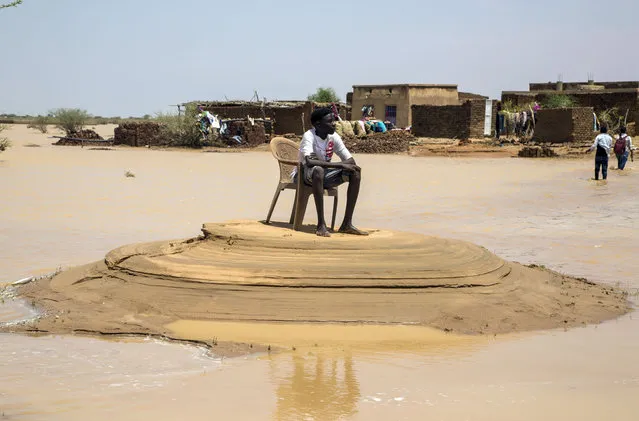 A stranded kid is seen after floods brought by the strong rains that were effective last week in the southeast of Khartoum, the capital of Sudan, continue to affect life negatively on August 03, 2020. (Photo by Mahmoud Hjaj/Anadolu Agency via Getty Images)