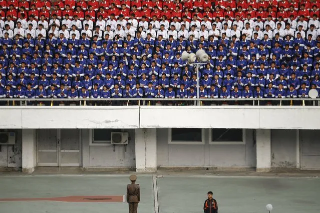 North Korean fans in national colours watch their team's preliminary 2018 World Cup and 2019 AFC Asian Cup qualifying soccer match against Philippines at the Kim Il Sung Stadium in Pyongyang October 8, 2015. (Photo by Damir Sagolj/Reuters)