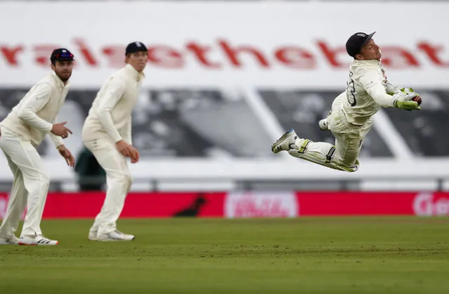 England's wicketkeeper Jos Buttler, right, dives to take the catch to dismiss Pakistan's Shaheen Afridi during the third day of the third cricket Test match between England and Pakistan, at the Ageas Bowl in Southampton, England, Sunday, August 23, 2020. (Photo by Alastair Grant/AP Photo/Pool)