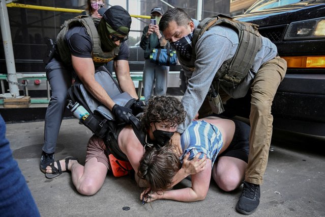 Law enforcement officers detain protesters as they block U.S. Immigration and Customs Enforcement (ICE) personnel from entering a building housing an immigration court amid federal immigration sweeps in Chicago on June 16, 2025. (Photo by Dylan Martinez/Reuters)