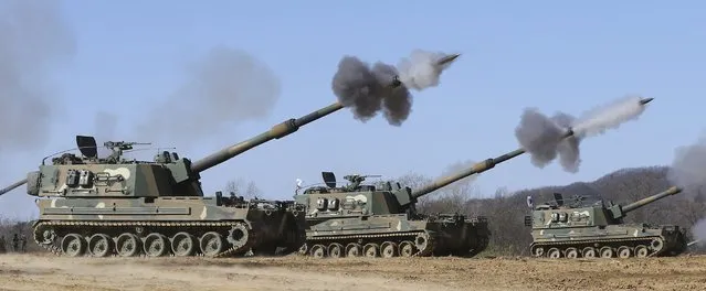 South Korean Army's K-9 self-propelled artillery fire during a military drill as a part of a nationwide joint military exercise involving the Army, Navy, Air Force and Marine Corps, in Yeonchon, north of Seoul, South Korea, Thursday, November 13, 2014. South Korean troops fired warning shots Monday after North Korean soldiers approached too close to the border separating the rival countries, Seoul defense officials said. (Photo by Im Byung-shik/AP Photo/Yonhap)