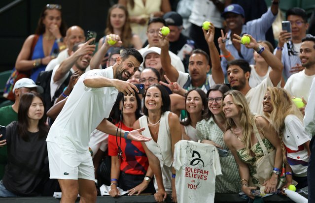 Serbia's Novak Djokovic poses for selfies with spectators after winning his first round match against France's Alexandre Muller during Wimbledon in London, Britain on July 1, 2025. (Photo by Toby Melville/Reuters)