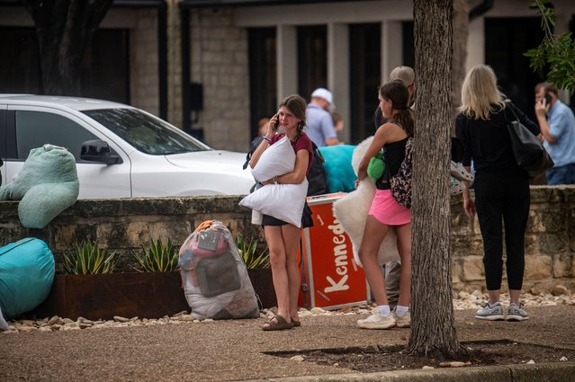 A girl speaks on the phone in an area where families were being reunited with campers after deadly flooding in Kerville, Texas, on July 5, 2025. (Photo by Sergio Flores/Reuters)