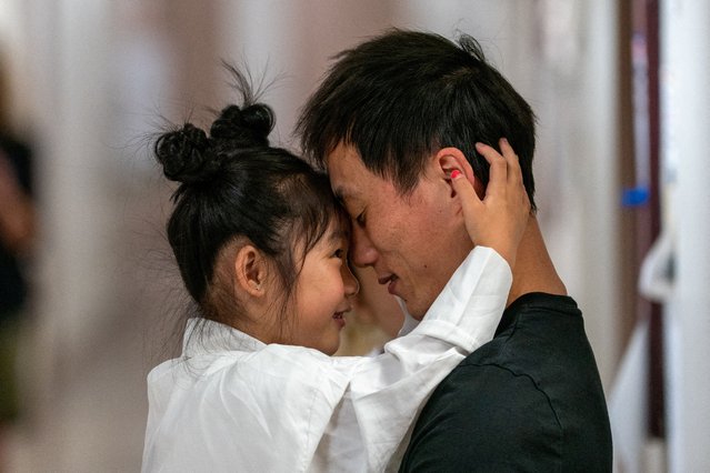 A child embraces her father after a hearing at a U.S. immigration court in Manhattan, New York City on July 22, 2025. (Photo by David 'Dee' Delgado/Reuters)