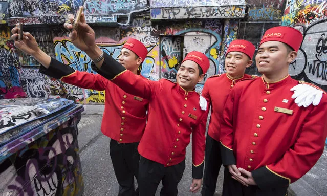 The world famous bell boys from the luxury cruise line Cunard sightseeing in graffiti lanways in the CBD on February 18, 2018 in Melbourne, Australia. Cunard today announced that their ship, Queen Elizabeth, will be based in the Victorian capital for a record two months over the 2019-20 summer, as part of an unprecendented 101 day season “Down Under” in Australia for the iconic ship. (Photo by James D. Morgan/Getty Images)