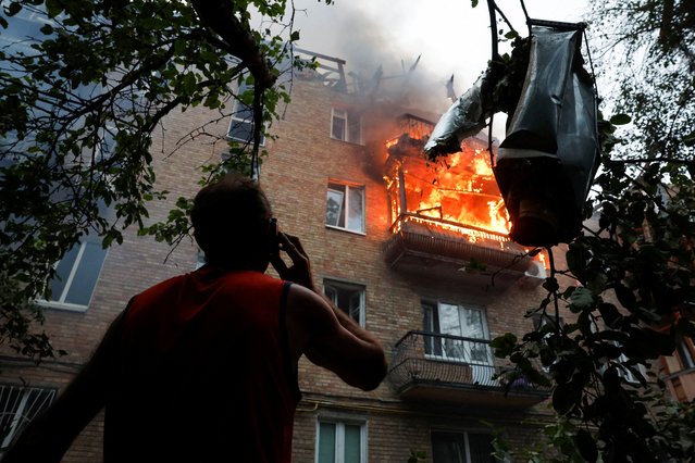A resident looks on at the site of an apartment building hit during Russian missile and drone strikes in Kyiv, Ukraine on July 31, 2025. (Photo by Thomas Peter/Reuters)