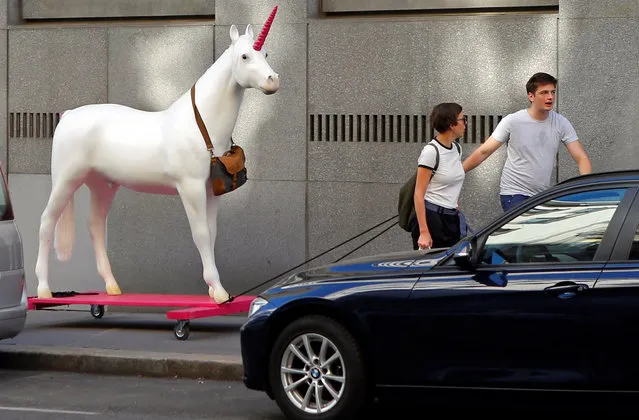 A unicorn mock-up, mascot of Vienna's Neos party, is being pulled along a street in Vienna, Austria September 30, 2016. (Photo by Heinz-Peter Bader/Reuters)