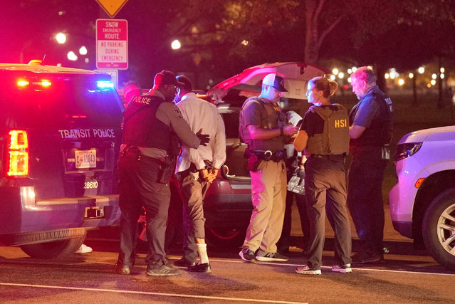 Metro Transit Police and Homeland Security Investigations officers search the vehicle of a person detained for a driver's licence issue, after Trump's announcement of the federal takeover of the DC Metropolitan Police Department, near tbe White House in Washington on August 14, 2025. (Photo by Ken Cedeno/Reuters)