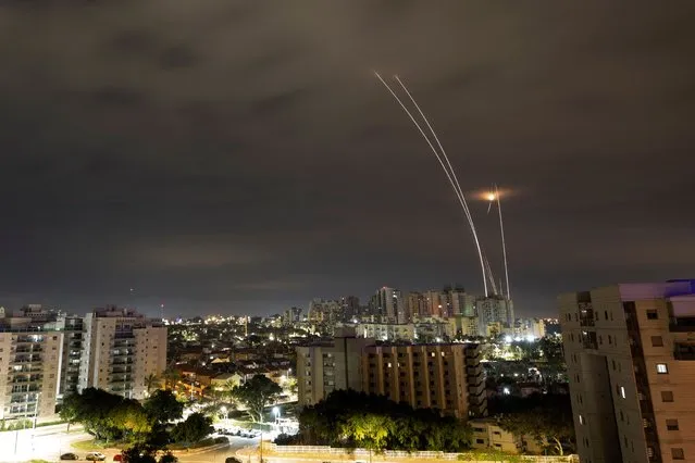 A trail of smoke is seen as rockets from Gaza are intercepted in the early morning, as seen from Ashkelon, Israel on February 23, 2023. (Photo by Amir Cohen/Reuters)