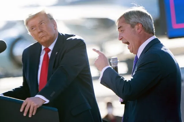 US President Donald Trump listens as Nigel Farage (R) speaks during a Make America Great Again rally at Phoenix Goodyear Airport October 28, 2020, in Goodyear, Arizona. (Photo by Brendan Smialowski/AFP Photo)