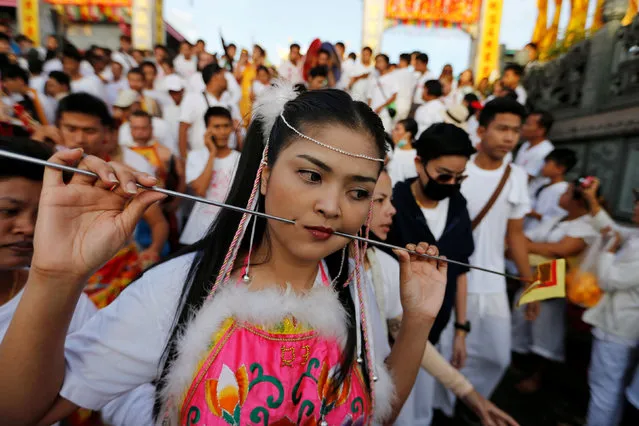 A devotee of the Chinese Jui Tui shrine takes with his mouth pierced with spikes takes part in a procession celebrating the annual vegetarian festival in Phuket, Thailand October 7, 2016. (Photo by Jorge Silva/Reuters)